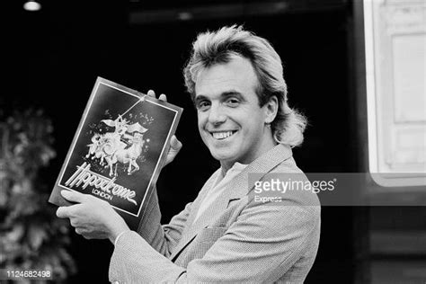 English Businessman And Nightclubs Owner Peter Stringfellow Holding A