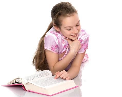 A Little Girl is Lying on the Floor Reading a Book. Stock Image - Image ...