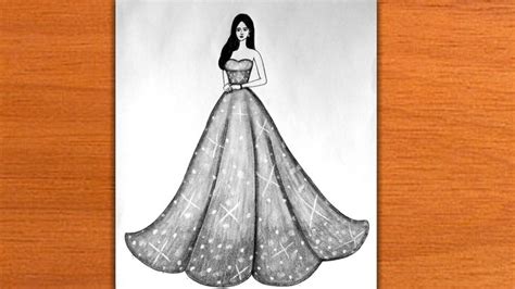 a drawing of a woman in a dress on a piece of paper that is sitting on a table