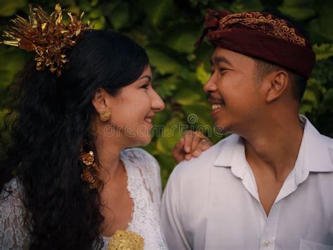 Portrait Of Multicultural Couple Wearing Traditional Balinese Clothing