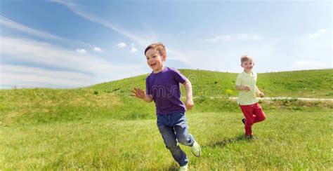 Happy Little Boys Running Outdoors Stock Photo - Image of life, meadow ...