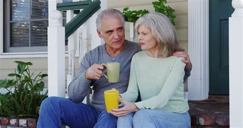 Mature Couple Sitting On Porch Talking Stock Footage Video 9061327