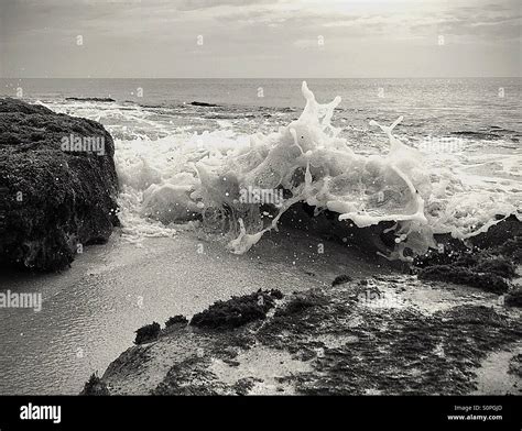 Black And White Image Of Waves Crashing Over Rocks Stock Photo Alamy