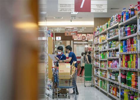 BANGKOK THAILAND MAY 02 Supermarket Employees Stocks Shelves With