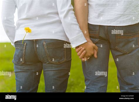 Couple of lovers holding hands Stock Photo - Alamy