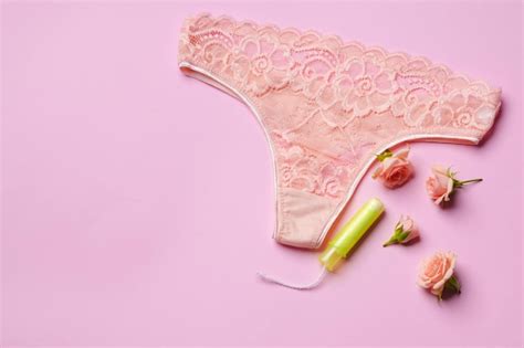 Premium Photo Womens Panties With Sanitary Tampon On Color Background