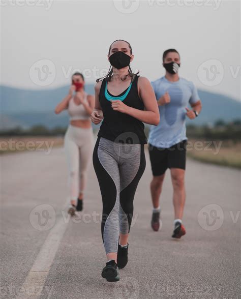 Multiethnic runners group wear face masks running keep social distance ...