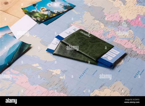 Passports And Tickets Placed On Paper World Map With Scenic Photos