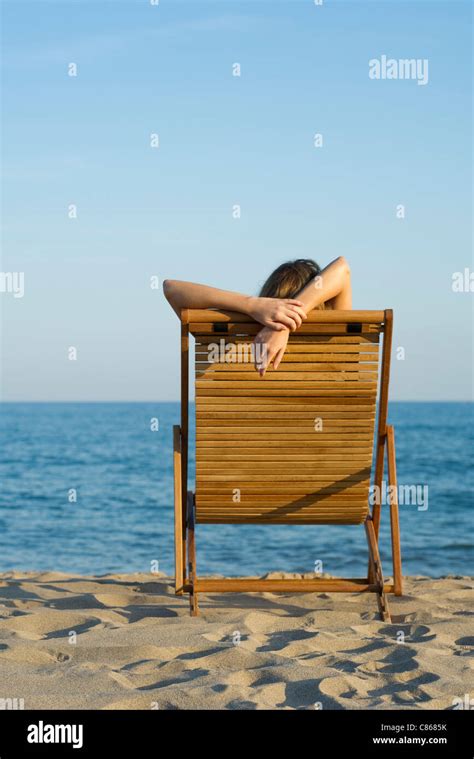 Woman Relaxing In Lounge Chair On Beach Stock Photo Alamy