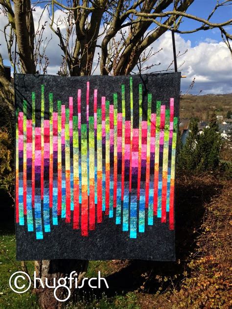 A Colorful Quilt Hanging From A Tree