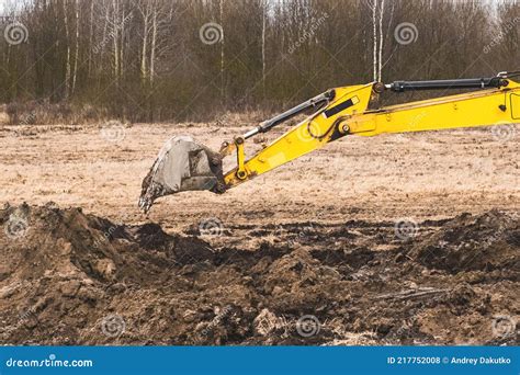 Excavator Bucket Digging A Trench In The Ground At A Construction Site