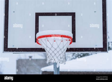 close    orange basketball hoop covered  snow stock photo