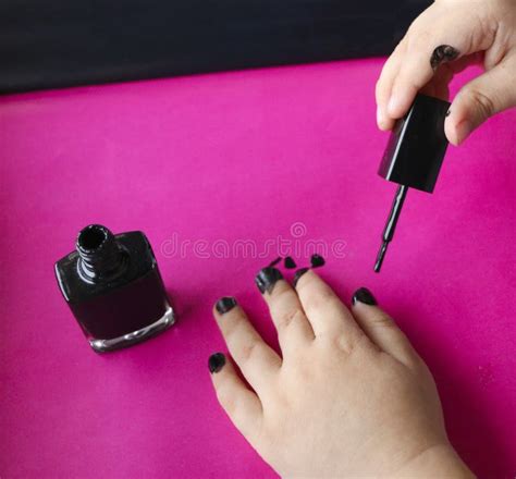 Children`s Hands Paint Their Nails with Black Nail Polish. Children`s ...