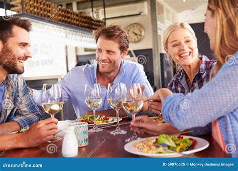 A Group Of Friends Eating At A Restaurant Stock Image Image Of Dining