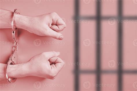 Hands In Handcuffs Behind Bars 11307808 Stock Photo At Vecteezy