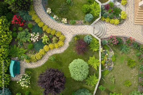 Garden With Walkways And Green Grass Photo Taken From Above Drone