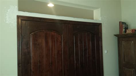 Installing double interior knotty alder doors.