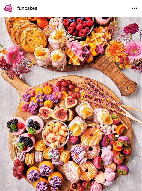 Two Wooden Trays Filled With Different Types Of Food