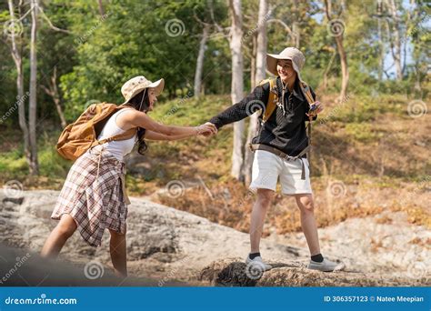 Cheerful Romantic Lesbian Couple Traveler With Backpack On Their Backs Go Hiking Through The