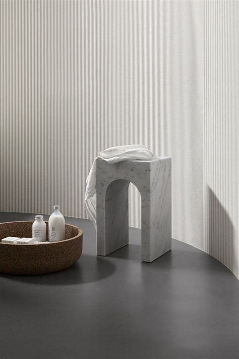 A Bathroom With A Marble Sink And Soap Dispenser