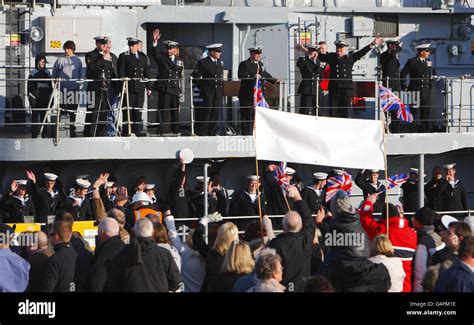 Crew members aboard HMS Edinburgh wave to their families as they return ...