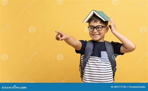 Excited School Aged Kid Boy with Book on His Head Stock Photo - Image ...