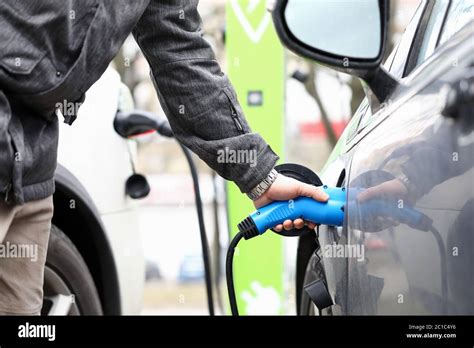 Man Fills Equipment Car Tank With Fuel Gas Station Stock Photo Alamy