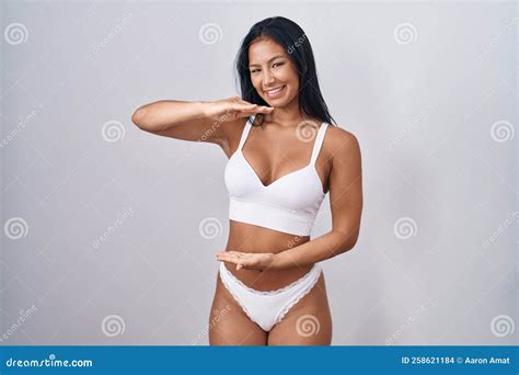 Hispanic Woman Wearing Lingerie Gesturing With Hands Showing Big And