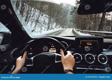 Male Driving On Forest Road During Wintertime Snow And Wet Roads