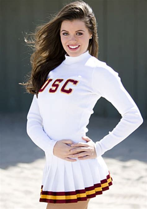 A Woman In A Cheerleader Outfit Posing For A Photo With Her Hands On Her Hips