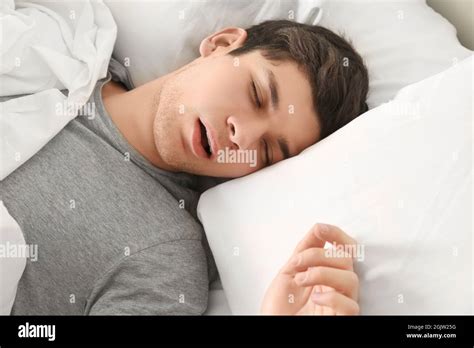 Handsome Young Man Sleeping In Bed At Home Stock Photo Alamy