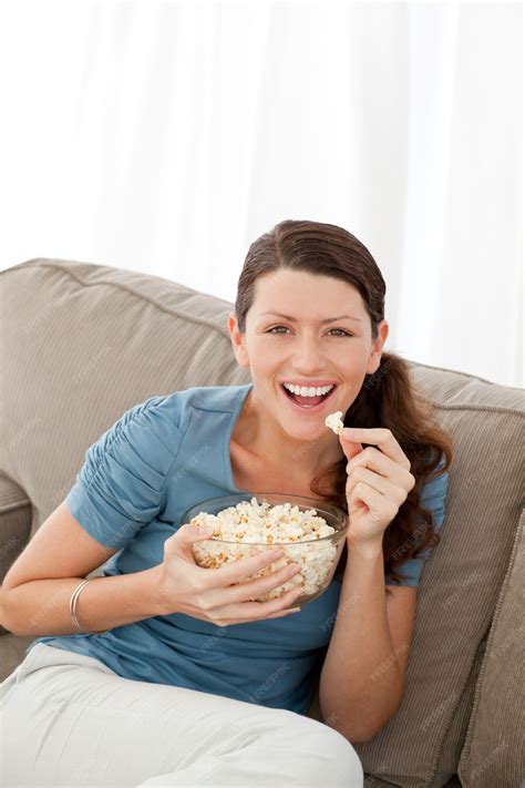 Premium Photo Portrait Of A Happy Woman Eating Pop Corn While