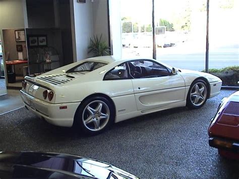 a white sports car parked in a showroom