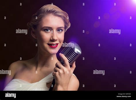 Attractive Female Singer With Microphone Stock Photo Alamy