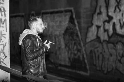 Premium Photo Side View Of Man Smoking Cigarette While Standing