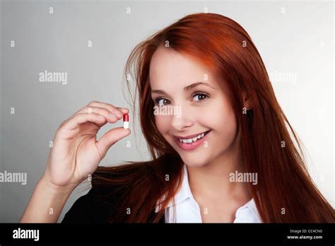 Woman Hold Up A Pill In Her Hand Stock Photo Alamy