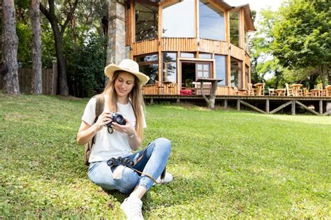 Free Photo Woman Sitting On Grass And Looking At Her Camera