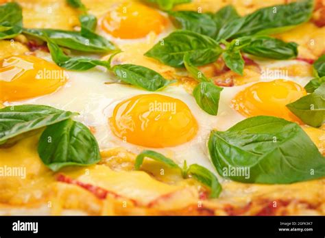 Margarita pizza with basil leaves and egg closeup Stock Photo - Alamy