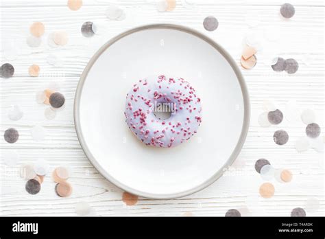 Delicious Colorful Donut With Sprinkles On Stylish Plate On White Table