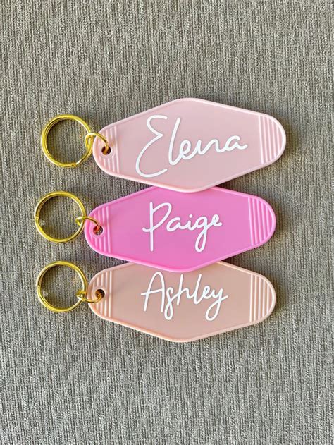 three personalized keychains with names on them