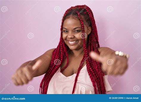 Mujer Afroamericana Con El Pelo Trenzado Sobre Fondo Rosa Aprobando