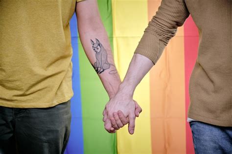 Premium Photo Homosexual Men Holding Hands When Standing Against