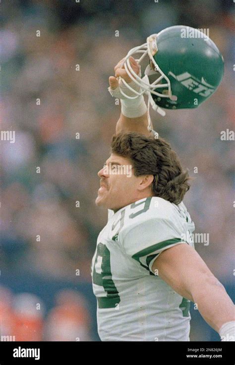 New York Jets Defensive End Mark Gastineau Raises His Helmet Above His