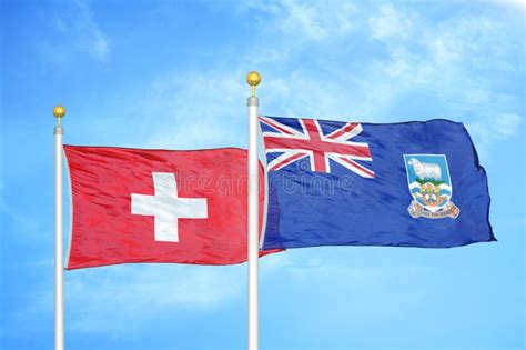 Switzerland And Falkland Islands Two Flags On Flagpoles And Blue Sky