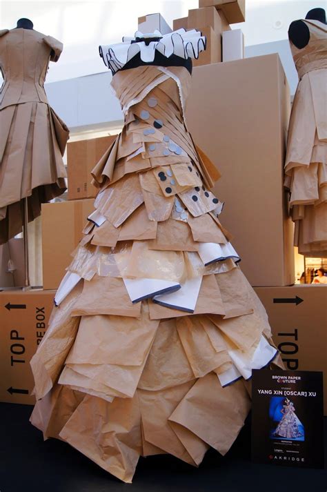 A Dress Made Out Of Brown Paper On Display