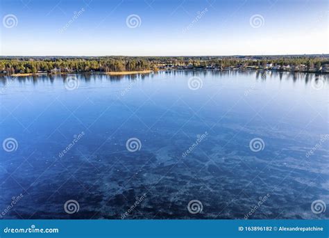 Aerial Scenic View Over Swedish Villages And Crystal Clear Frozen Lake