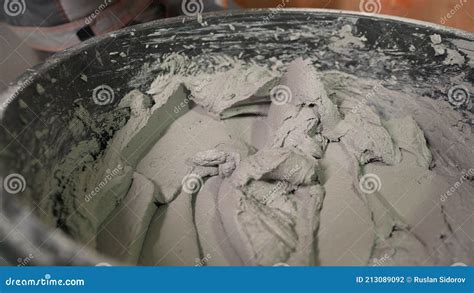 Builder Mixing Plaster In A Bucket Using An Electric Mixer Mixing