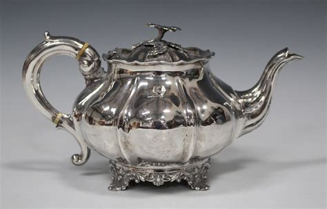 An Early Victorian Silver Teapot Of Lobed Circular Form With Flower