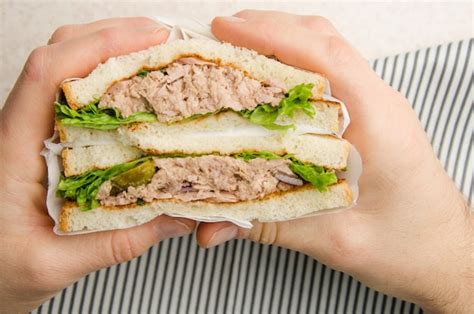 Premium Photo Wrapped Tuna Sandwiches With Lettuce Pickles And Onions