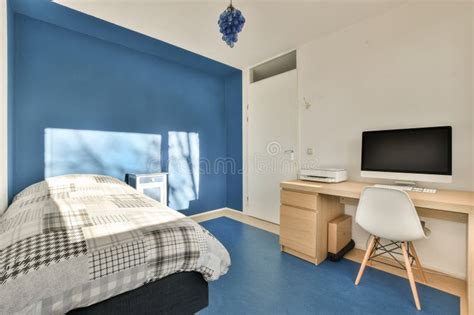 A Bedroom with a Bed a Desk and a Television Stock Photo - Image of ...